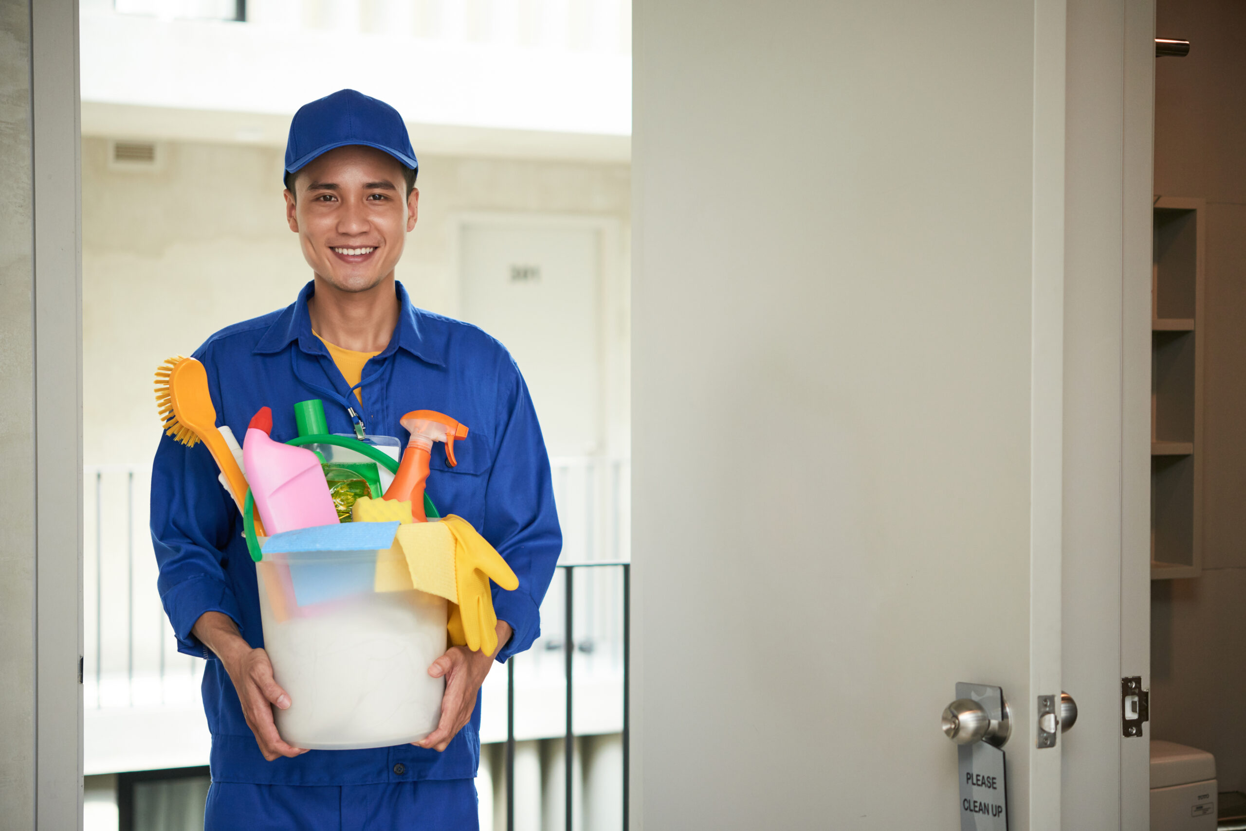 Portrait of young Asian cleaning manager with bucket of cleaning supplies